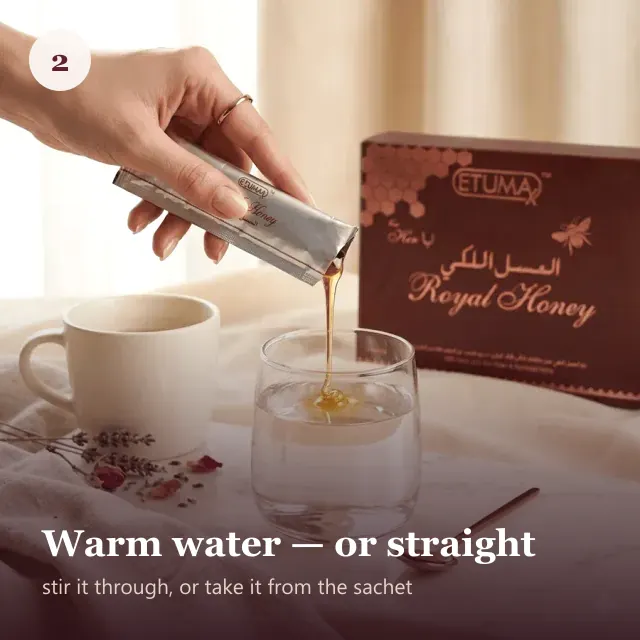A sachet of honey being poured into a glass of warm water